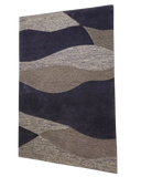 Modern purple and beige area rug featuring layered wavy texture, stylish home interior centerpiece.