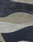 Hand tufted plum purple wave rug with beige accents for bedroom, dining room, or living space.