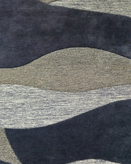 Hand tufted plum purple wave rug with beige accents for bedroom, dining room, or living space.