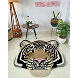 Hand tufted irregular wool rug featuring realistic tiger face in modern living space with plants and lamps
