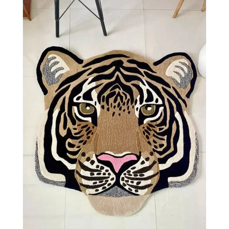 Hand-tufted wool rug shaped like a realistic tiger face with black, beige, white, and pink accents on tiled floor