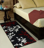 Red floral hand tufted wool runner rug beside bed in cozy bedroom setting