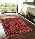 Red wool rug with white geometric tufted pattern in modern living room with hardwood floor