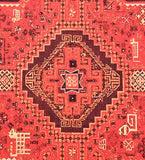 Close-up of luxury red tribal rug with intricate geometric patterns and earthy accents