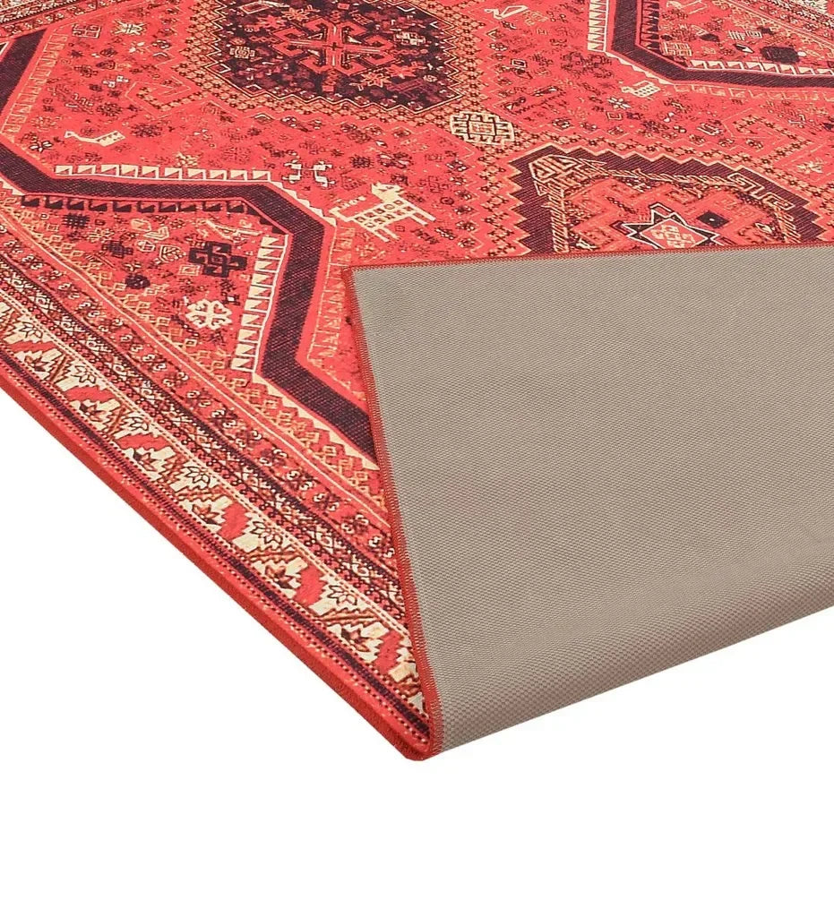 Durable red rug with cultural-inspired design.