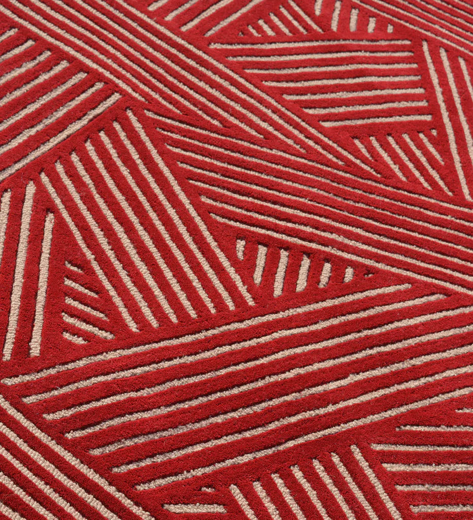 Contemporary hand-tufted rug with bold red and beige geometric design.