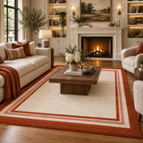 Red border wool area rug styled in a living room 8x10