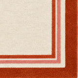 Detail of red framed border and ivory center on hand-tufted wool rug