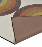 Close-up of a retro rainbow geometric arch area rug with warm earthy tones and a beige background from Mannat Rugs