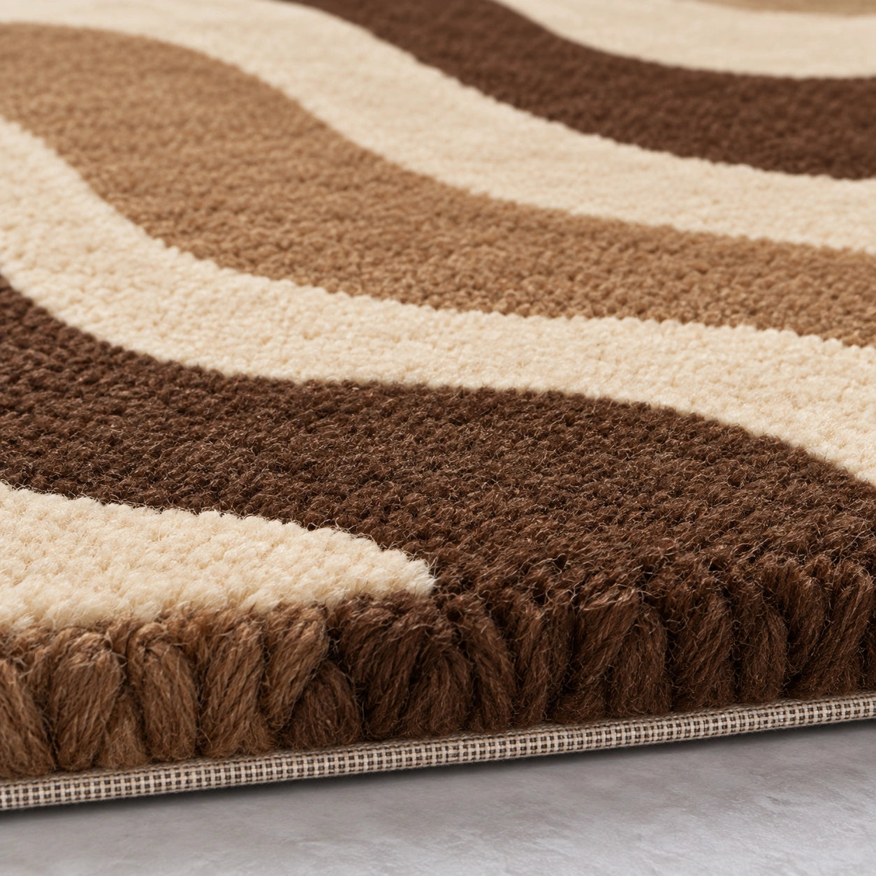 Brown and cream wavy area rug styled in a modern living room, 9x12 size