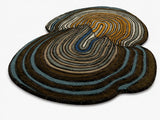 Round, multicolored rug with concentric circle pattern on a white background