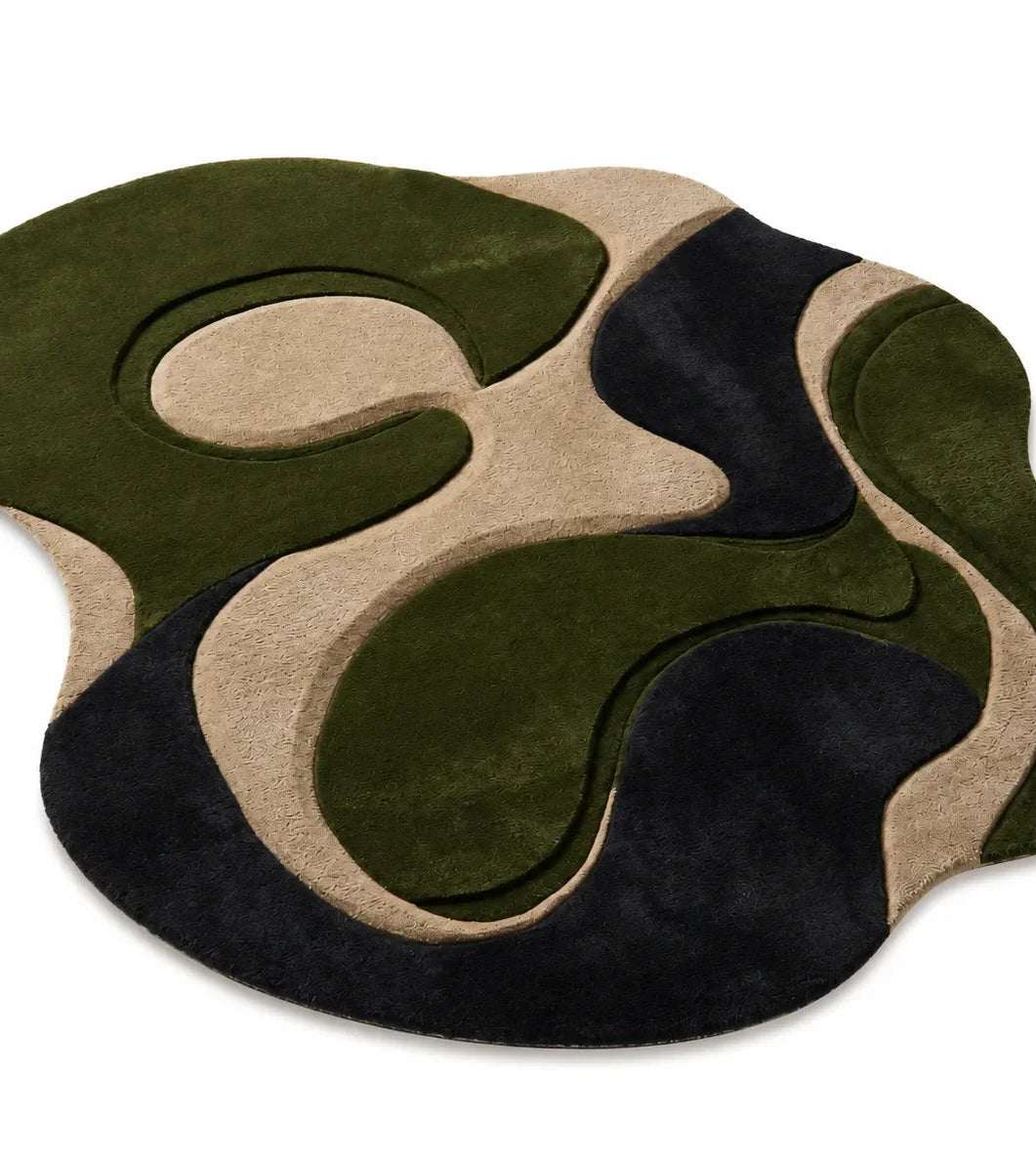 Rug with green, black, and beige abstract design on a white background

