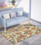 Rust mustard floral watercolor style rug in living room with light blue sofa and wooden floor
