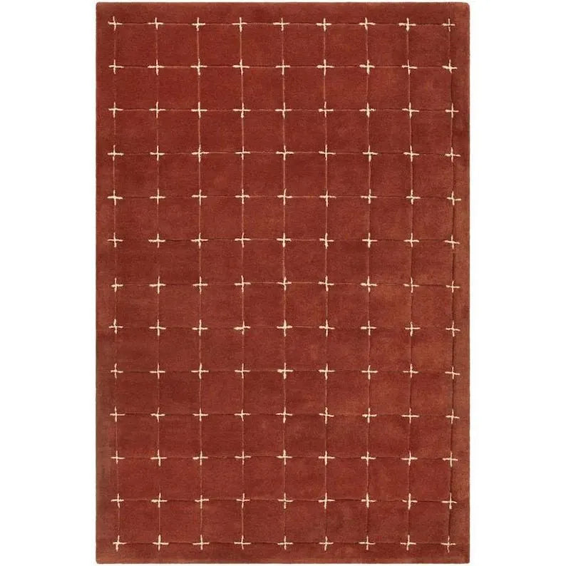 Hand-tufted rustic red wool rug with cream grid pattern.