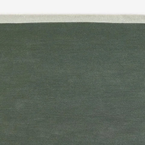 Soft sage green wool carpet with clean cream trim - hand-tufted rug for cozy spaces