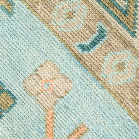 Soft blue geometric medallion rug with handwoven detailing