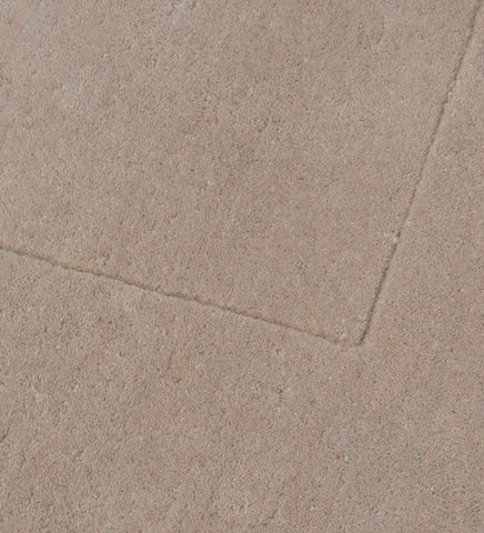 Luxury solid hand-tufted wool rug with soft beige tone
