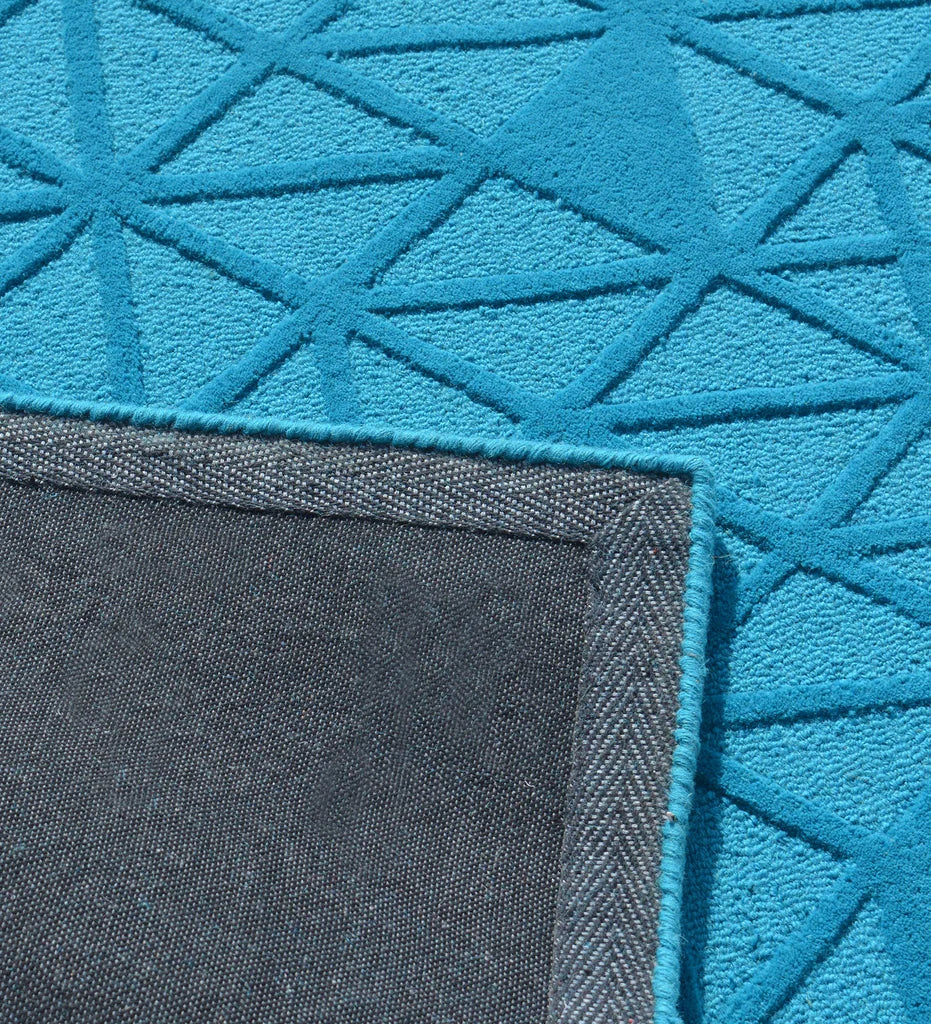 Minimalist hand-tufted rug in bold blue with subtle geometric design