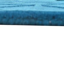 Embossed geometric blue wool rug for modern interiors