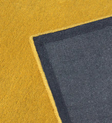 Handcrafted golden yellow wool rug with minimalist border