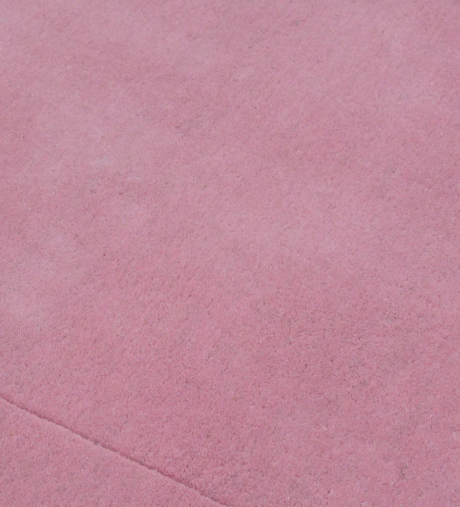 Luxury solid pink wool rug with subtle border detail