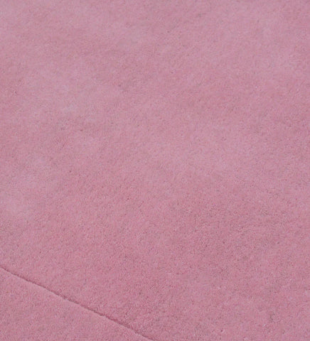 Luxury solid pink wool rug with subtle border detail