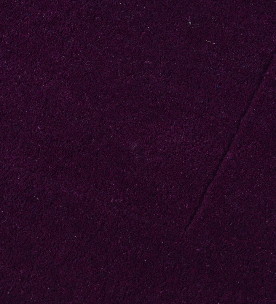 Luxury solid purple rug with subtle border design