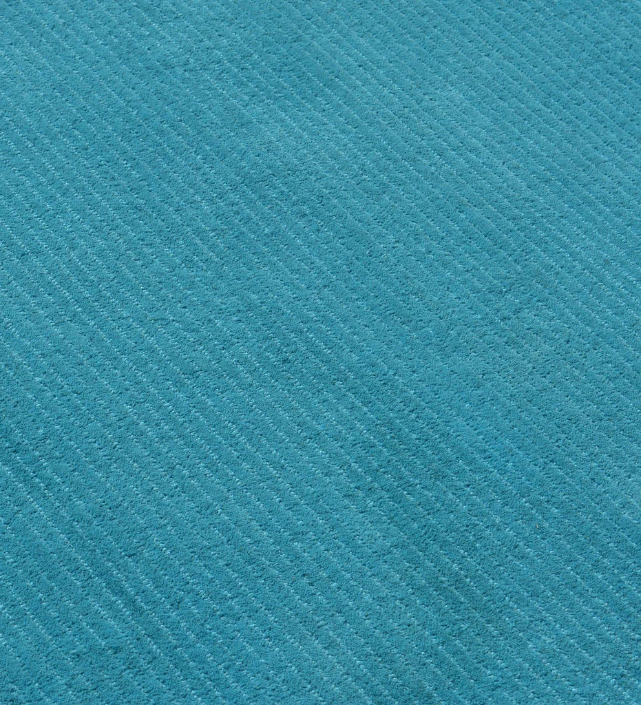 Luxury teal wool rug with contemporary textured finish
