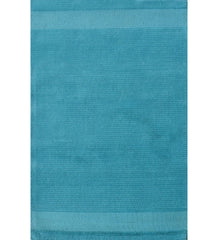 Solid teal hand-tufted wool rug with minimalist linear design