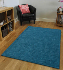 Solid teal wool rug featuring embossed grid pattern