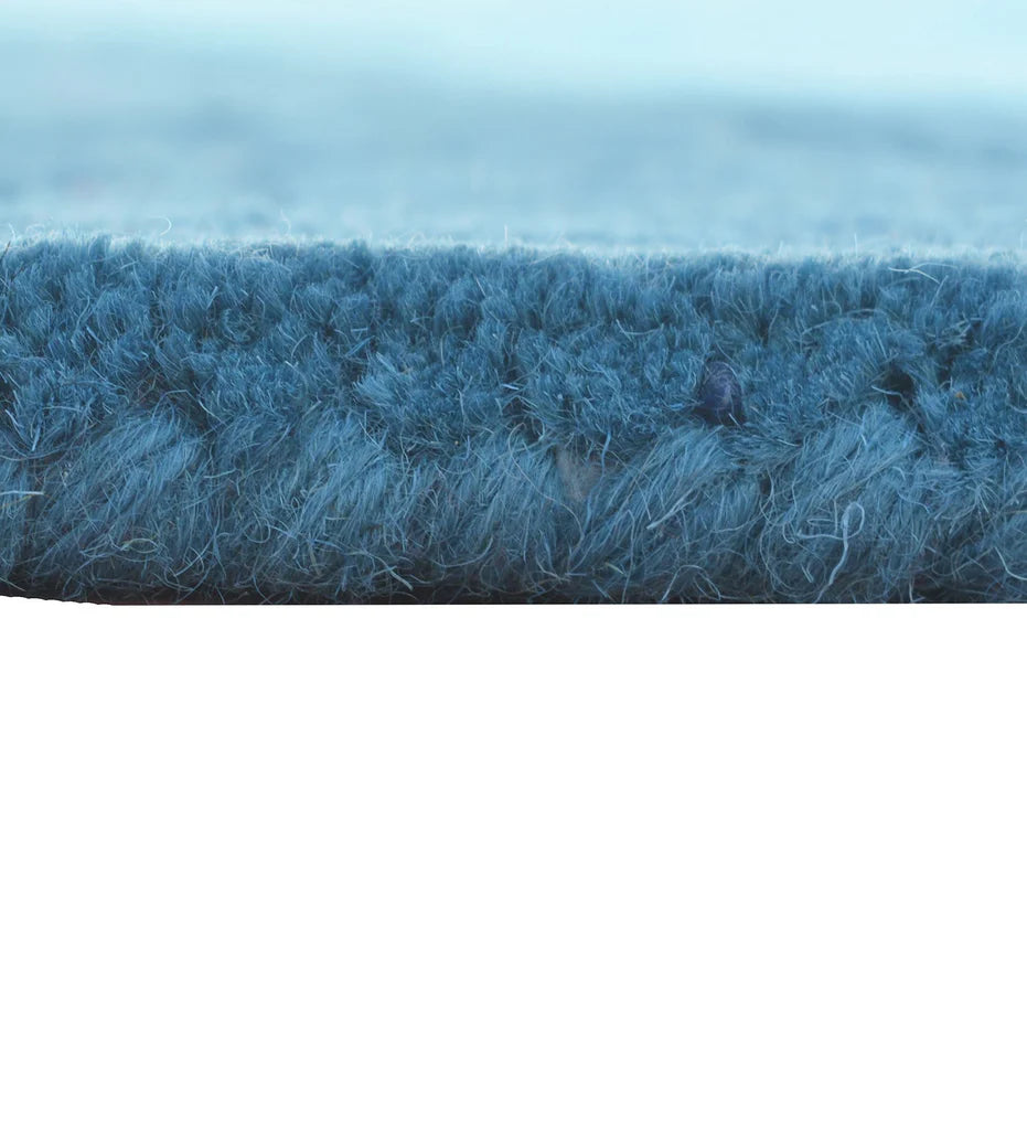 Hand-tufted teal wool rug with embossed contemporary design