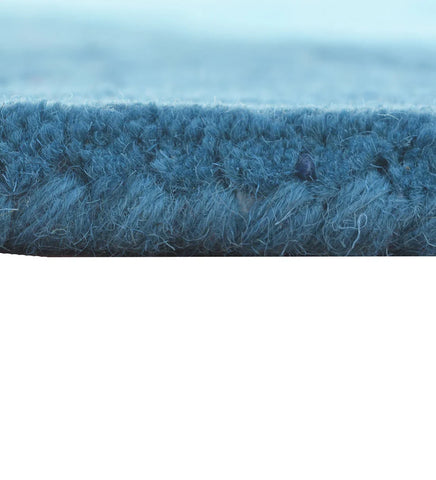 Hand-tufted teal wool rug with embossed contemporary design