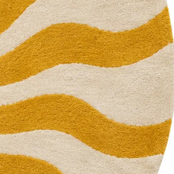 A round area rug featuring a bold sunburst pattern with wavy rays in mustard yellow on an off-white background.