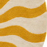 A round area rug featuring a bold sunburst pattern with wavy rays in mustard yellow on an off-white background.
