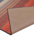 Close-up of a striped Sunset Horizon handwoven rug with red and beige tones, showing its textured back
