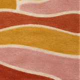 A square area rug featuring a retro sunset and wave design in warm colors including orange, yellow, pink, cream, and dark purple.