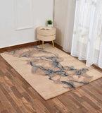 Taupe abstract river design rug on wood floor in minimalist room with round beige stool and sheer white curtains