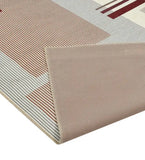 Taupe modern geometric rug with striped square patterns in earth tones, folded corner showing woven texture