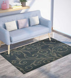 Taupe and charcoal transitional area rug with swirling vine pattern under modern light blue sofa in bright room