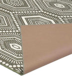 Taupe and ivory boho hexagon patterned rug with folded corner showing backing, handwoven luxury design
