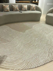 Designer oval area rug with flowing white lines and neutral base.