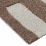 Close-up of taupe and cream handwoven abstract pattern rug with soft texture