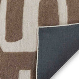 Luxury taupe and cream abstract pattern handwoven rug with dark gray backing corner fold