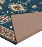 Teal blue rustic handwoven rug with geometric and floral patterns and a beige non-slip backing corner