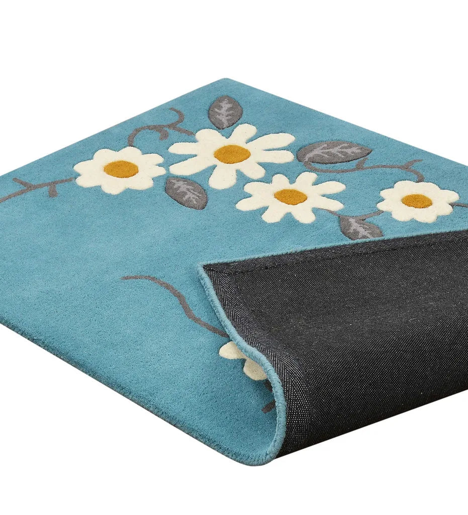 Playful hand-tufted floral rug with teal blue base