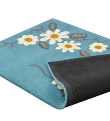 Playful hand-tufted floral rug with teal blue base