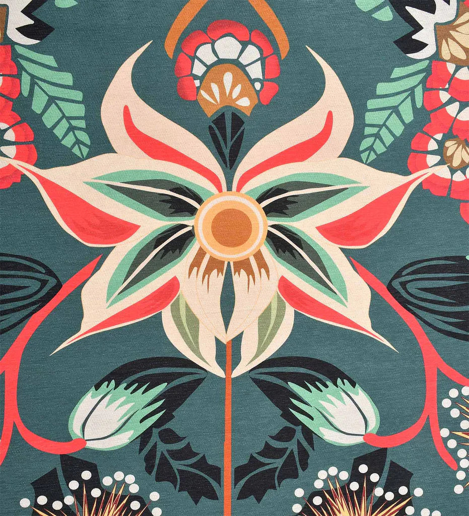 Low-profile teal rug with cream and mustard floral accents.