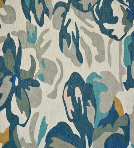 Artistic floral rug in teal and aqua tones.