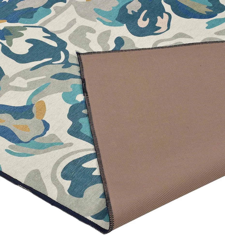 Teal and white watercolor floral area rug.