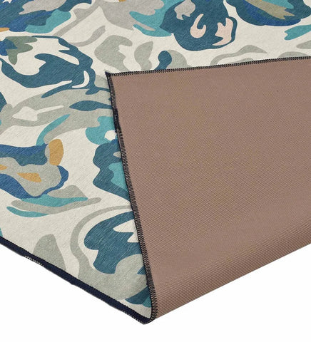 Teal and white watercolor floral area rug.
